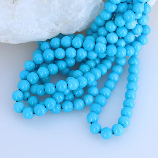 Turquoise bead necklace on a white background