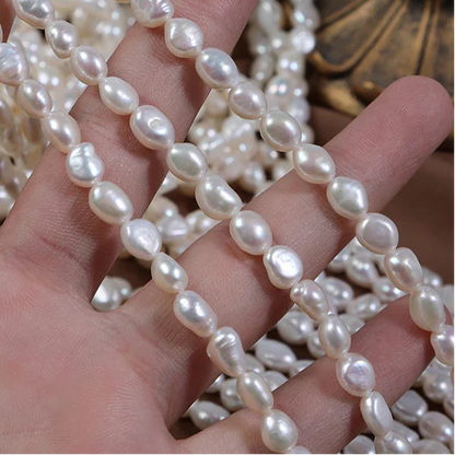 Pearl strand held in a hand with a decorative background